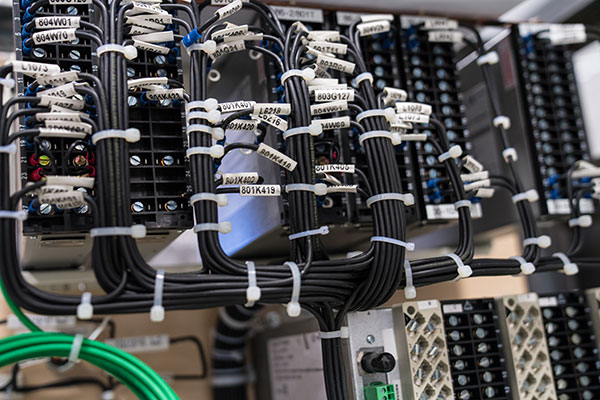 wires neatly organized and labeled on the back of a control panel