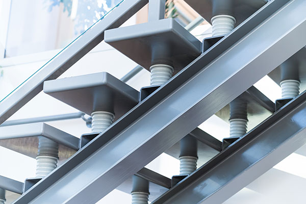 Custom-built stairs at the Dynamo front lobby in Saskatoon, Saskatchewan. The risers are designed to look like electrical insulators.